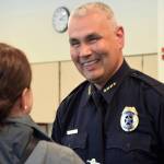 Juneau Police Department Chief Ed Mercer is all smiles while being congratulated by District Attorney Angie Kemp after his swearing-in Monday, July 31. (Liz Kellar | Juneau Empire File)