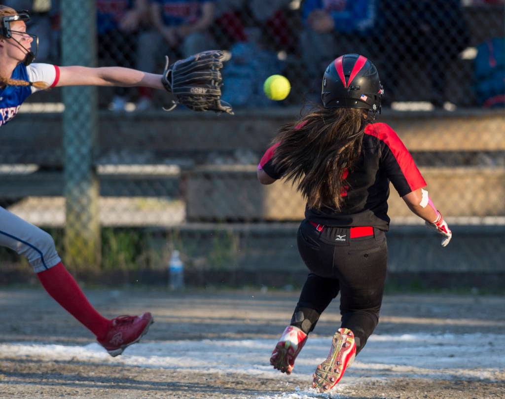 Juneau-Douglas&rsquo; Asianna Mazon, right, scores ahead of the throw to Sitka&rsquo;s Kyler Sumauang in the fifth inning at Melvin Park on Friday, May 18, 2018. (Michael Penn | Juneau Empire)