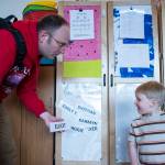 Mark Neeland helps his son, Elliot, 3, find his name while dropping him off at Gold Creek Child Development Center on Thursday, May 24, 2018. (Michael Penn | Juneau Empire)
