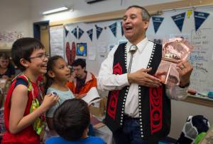 Tlingit Culture, Language and Literacy Program teacher Rocky Eddy displays a copper Tin&
