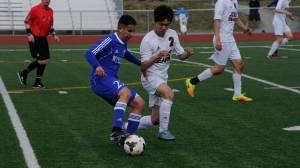 Juneau-Douglas High School junior ChaeHun Yi defends Kodiak High School senior Daniel Carrillo in the ASAA Division II boys soccer state championships on Thursday, May 24, 2018 at Eagle River High School. JDHS won 5-2. (Nolin Ainsworth | Juneau Empire)
