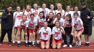 The Juneau-Douglas High School girls soccer team poses after winning the ASAA Division II state championship at Service High School in Anchorage on Saturday. Back Row (L to R): Coach Phil Subeldia, Jasmin Holst, Makenna Graham, Chloe Smith, Nikki Box, Nicole Mannix, Michaela Bentley, Jessie Mayer, Bailey Wery Tagaban, Coach Matt Dusenberry. Middle Row: Taylor Bentley, Katja Steimann, Brianna Jokerst, Shaylin Cesar, Malia Miller, Eva Goering, McKenzie Dimond. Front Row: Marlena Romanoff, Erica Hurtte. (Nolin Ainsworth | Juneau Empire)