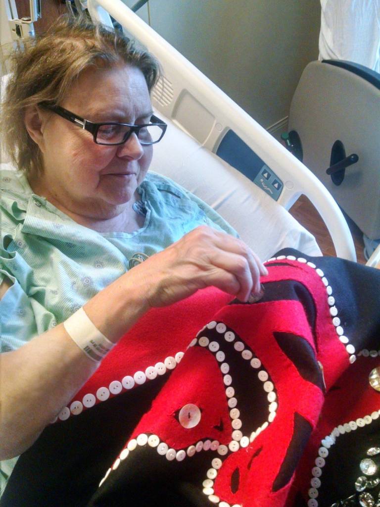 Lynn Alme works on the blanket while in the hospital. Courtesy image.