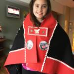 Leah Nelson shows off her button blanket. Courtesy image.