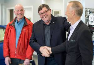 Mendenhall Auto co-owners Steve Allwine, center, and Mark Troupin, left, congratulate Doug Scudder, president of the Board of Directors for Trail Mix Inc., after they presented $8,585 to Trail Mix at Mendenhall Auto on Tuesday, May 29, 2018. The donation is part of Subaru&rsquo;s &ldquo;Share the Love&rdquo; promotion. (Michael Penn | Juneau Empire)