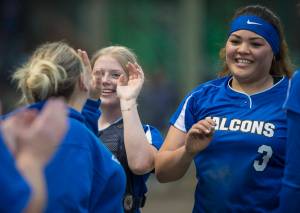 Thunder Mountain&rsquo;s Nina Fenumiai, right, and Rachel Macaulay receive high-fives from Coach Brittany Gladsjo after beating Juneau-Douglas at Melvin Park earlier this month. Thunder Mountain plays Kodiak and North Pole in the state tournament today in Fairbanks. (Michael Penn | Juneau Empire File)