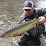Mark Hieronymus poses with a steelhead caught in 2014 on a Southeast Alaskan river. (Photo by Tyson Fick)