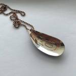 Engraved pendant of a mussel by Jennifer Younger. Photo courtesy of Jennifer Younger.
