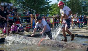 Ryan Friend, left, loses to Ralph &ldquo;Animal&rdquo; Austin during the log rolling contest at the 27th Annual Gold Rush Days Competition at Savikko Park on Sunday, June 18, 2017. (Michael Penn | Juneau Empire File)