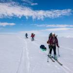 Britney Ooman, Matt Roda, Rylee Landon, and Jason Colon skinning with blue skies. (Gabe Donohoe | For the Juneau Empire)