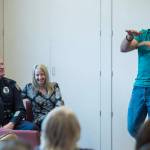 Officer Blain Hatch, left, watches with his wife, Tiffany, as his twin brother, Paul, tells a story during his retirement party at the Juneau Police Station on Friday, June 1, 2018. Blain Hatch retired after working 25 years with the department. Paul Hatch retired from the Juneau Police Department with nearly 21 years in 2013. (Michael Penn | Juneau Empire)
