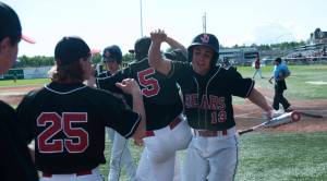 Michael Cesar and the Juneau-Douglas High School baseball team celebrates their state championship win in Anchorage. (Michael Dinneen | For Juneau Empire)