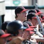Juneau-Douglas High School baseball player Erik Kelly cheers his team on from the dugout during the ASAA state championship game Saturday. (Michael Dinneen | For the Juneau Empire)