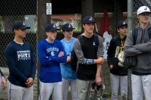 Juneau Post 25 players listen to the coaching staff after practice at Adair-Kennedy Memorial Park on Wednesday. (Nolin Ainsworth | Juneau Empire)