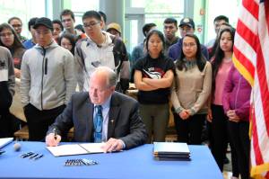 Alaska Gov. Bill Walker signs state spending bills during a ceremony Wednesday at the University of Alaska Anchorage. Walker did perform some line-item vetoes, including rejecting funding for a bridge project that would link Anchorage to the Matanuska-Susitna Borough and a Vitamin D deficiency study. (AP Photo/Mark Thiessen)