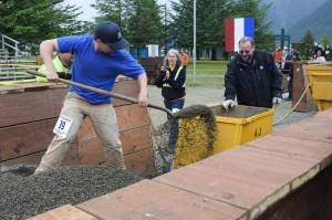 Conner Ryan takes his turn at the men&rsquo;s hand mucking event at Gold Rush Days on Saturday. (Kevin Gullufsen | Juneau Empire)