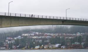 A bicyclist cross the Douglas Bridge in November 2012. The bridge is the only connection to Douglas Island from the mainland. (Michael Penn | Juneau Empire File)
