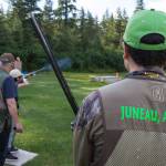 Brice Norton, right, waits his turn as Coach Mark Kappler watches Mackenzie Lam practice trap shooting at the Juneau Gun Club on Thursday. (Michael Penn | Juneau Empire)