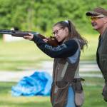 Coach Mark Kappler watches as Renee Win practices her trap shooting at the Juneau Gun Club on Thursday. (Michael Penn | Juneau Empire)