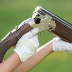 Mackenzie Lam reloads her double-barrel shotgun during trap shooting at the Juneau Gun Club on Thursday. (Michael Penn | Juneau Empire)