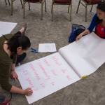 Darlene Trigg and Heather Gatti write out questions before the Wisdom in the Circle meeting at Elizabeth Peratrovich Hall on Monday, June 25, 2018. The event is hosted by Tlingit & Haida, AWARE, and the Juneau Violence Prevention Coalition. (Michael Penn | Juneau Empire)