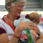 Red Cross Mental Health Service Associate Annie Caulfield, a Juneau resident, holds a baby while deployed in Hawaii in May 2018. Caulfield and other volunteers were there in response to the Kilauea Volcano eruption that has displaced thousands of people. (American Red Cross | Courtesy Photo)