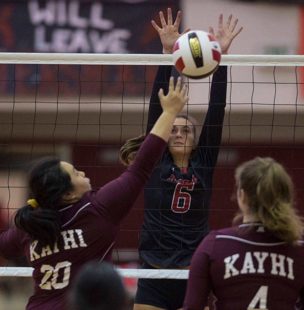 Juneaus Addie Prussing, center, goes to block Ketchikans`Ada Hu hit at Juneau-Douglas High School on Friday, Aug. 31, 2018. (Michael Penn | Juneau Empire)