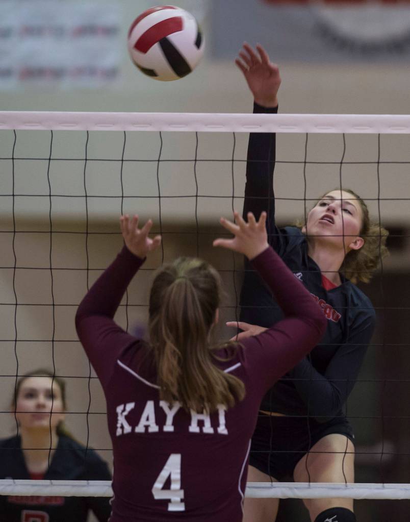 Juneaus JoJo Griggs spikes over Ketchikans Jenae Rhoads at Juneau-Douglas High School on Friday, Aug. 31, 2018. (Michael Penn | Juneau Empire)