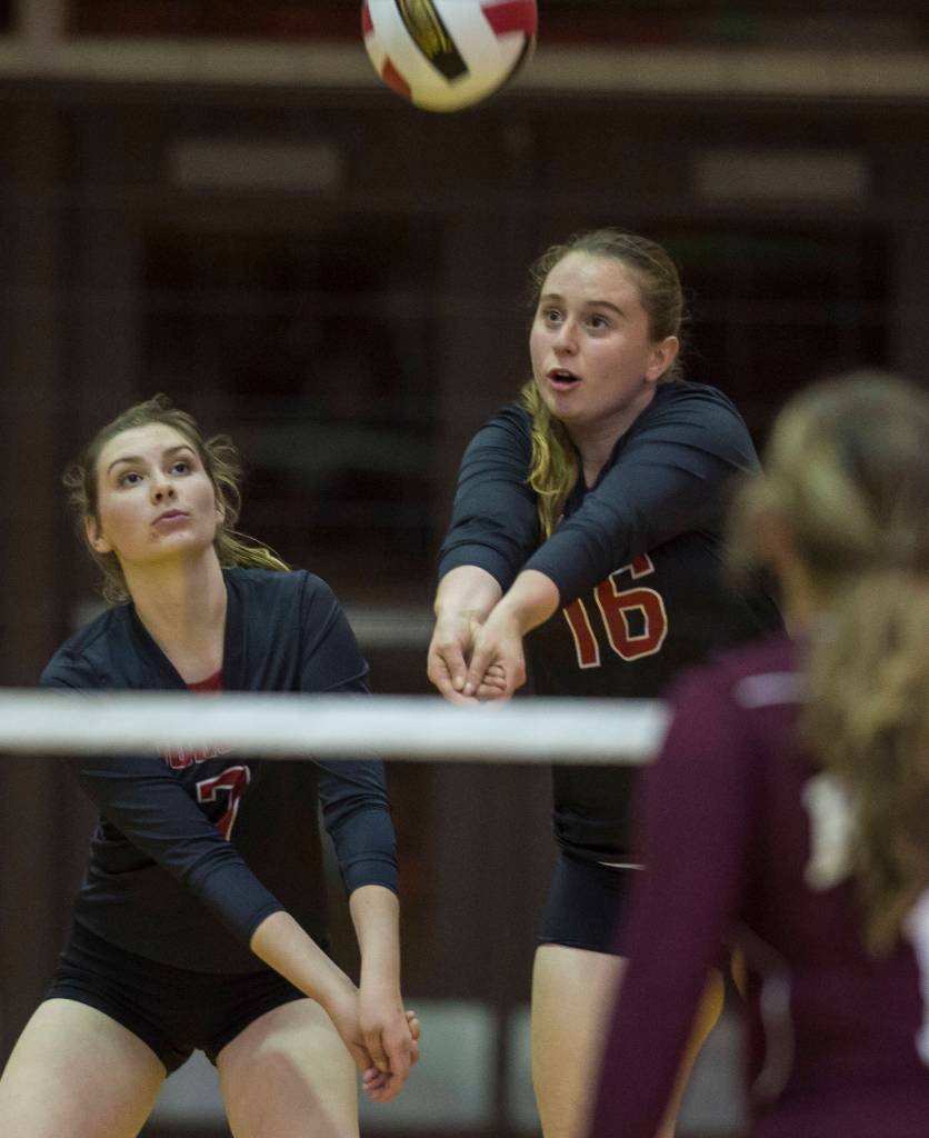 Juneaus Shaylin Cesar, right, bumps the ball against Ketchikan as teammate Riley Stadt backs her up at Juneau-Douglas High School on Friday, Aug. 31, 2018. (Michael Penn | Juneau Empire)