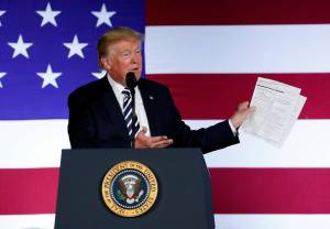 In this Aug. 31, 2018 photo, President Donald Trump holds up a list of his administrations accomplishments while speaking at a Republican fundraiser at the Carmel Country Club in in Charlotte, N.C. (AP Photo | Pablo Martinez Monsivais)
