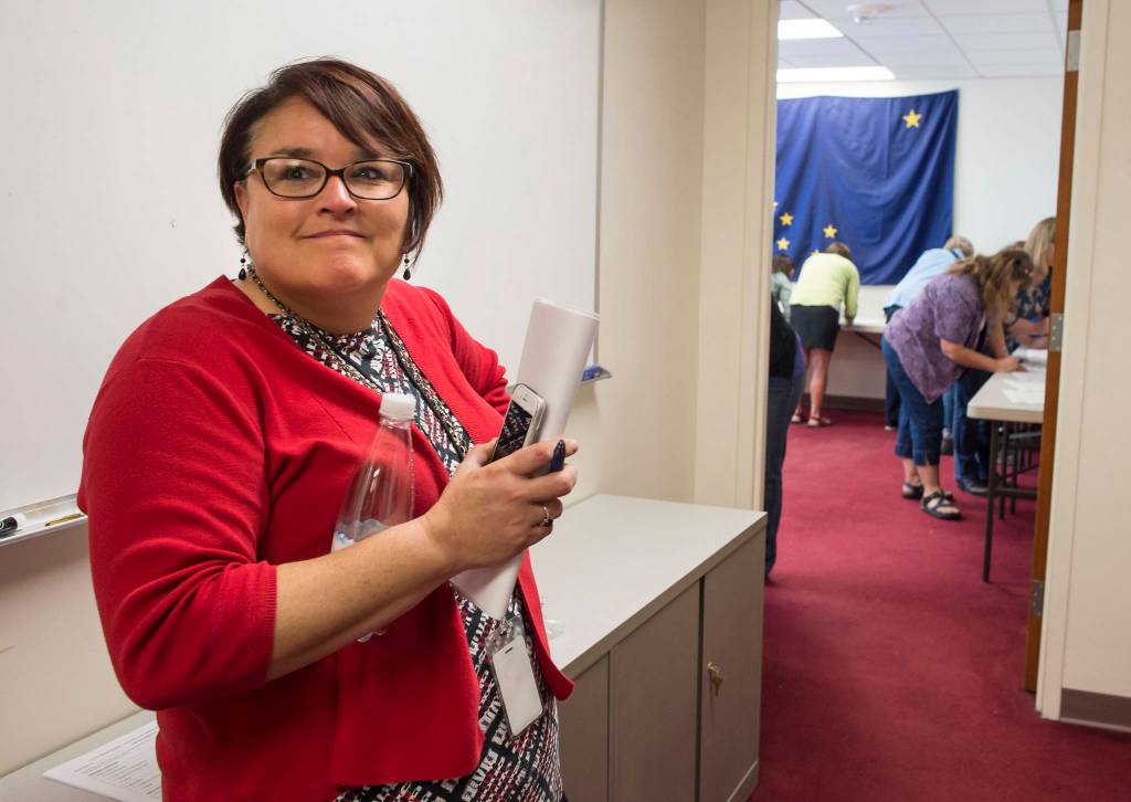 Josie Bahnke, State of Alaskas Director of Elections, waits as Alaska Review Board members sign the final certifications of the states primany election at the states election office in downtown Juneau on Tuesday, Sept. 4, 2018. (Michael Penn | Juneau Empire)