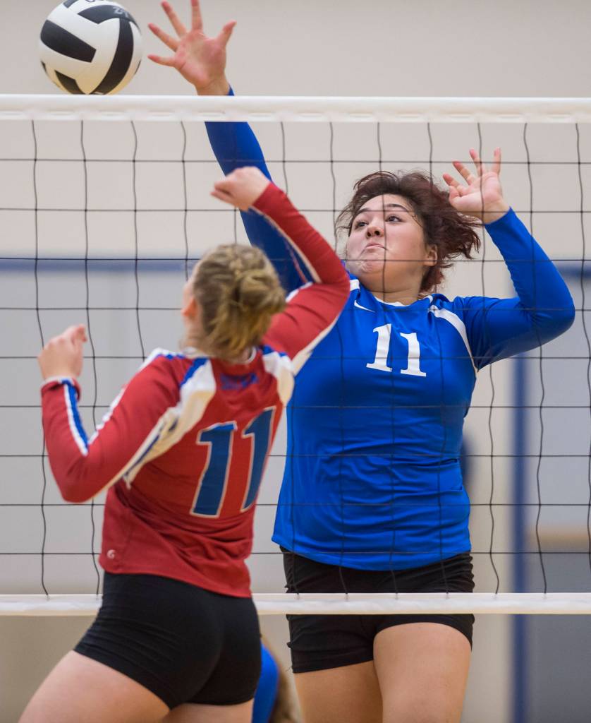 Thunder Mountains Letasiilemilion Fenumiai, right, hits against Sitkas Abby Forrester at Thunder Mountain High School on Friday, Sept. 7, 2018. Thunder Mountain won 3-0 (25-15, 25-21, 25-16). (Michael Penn | Juneau Empire)