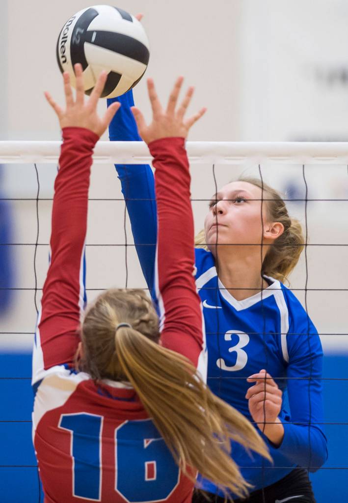 Thunder Mountains Lilyan Smith spikes against Sitkas Kenzie Fredrickson at Thunder Mountain High School on Friday, Sept. 7, 2018. Thunder Mountain won 3-0 (25-15, 25-21, 25-16). (Michael Penn | Juneau Empire)