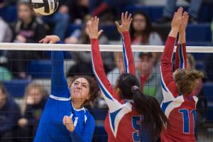 Thunder Mountains Letasiilemilion Fenumiai, left, hits against Sitkas Joei Vidad, center, and Abby Forrester at Thunder Mountain High School on Friday, Sept. 7, 2018. Thunder Mountain won 3-0 (25-15, 25-21, 25-16) (Michael Penn | Juneau Empire)