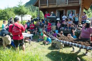 TRAYLS crew and Ha Too Yeiti camp members watch as Ralph Wolfe of Yakutat shows how to process sockeye fillets. (Courtesy Photo | Ian Johnson)