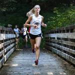 Juneau-Douglas junior Sadie Tuckwood takes the lead on Saturday during a Region V cross country meet at Ward Lake in Ketchikan. Tuckwood placed first in the girls race. (Dustin Safranek | Ketchikan Daily News)