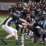 Juneau Uniteds Gaven Smith, left, and Hansel Hinckle push Chugiaks Christian Beesing out of play at Adair-Kennedy Memorial Field on Friday, Sept. 14, 2018. A penalty was called on the play. Chugiak won 22-7. (Michael Penn | Juneau Empire)