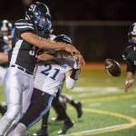 Juneau Uniteds William Skinna, left, knocks the ball away from Chugiaks Tyler Huffer at Adair-Kennedy Memorial Field on Friday, Sept. 14, 2018. Skinna recovered the ball on the play for a turnover. Chugiak won 22-7. (Michael Penn | Juneau Empire)
