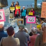 Juneau residents listen to Kate Troll as they participate in a protest against President Donald Trumps nominee to the Supreme Court, Brett Kavanaugh, at Dimond Courthouse Plaza on Tuesday, Sept. 18, 2018. (Michael Penn | Juneau Empire)