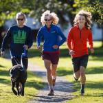 Merry Ellefson, center, runs with her son, Arne Ellefson-Carnes, right, and co-coach Tristan Knutson-Lombardo during Juneau-Douglas High School cross country practice on Wednesday, Sept. 19, 2018. Merry is a co-coach for the team and Arne is a senior. (Michael Penn | Juneau Empire)