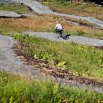 Ron Flint takes a ride on the completed lower section of a mountain bike trail at the Eaglecrest Ski Area August 2015. Volunteers with the Juneau Freewheelers Cycle Club and Eaglecrest staff worked on the downhill trail. (Michael Penn | Juneau Empire)