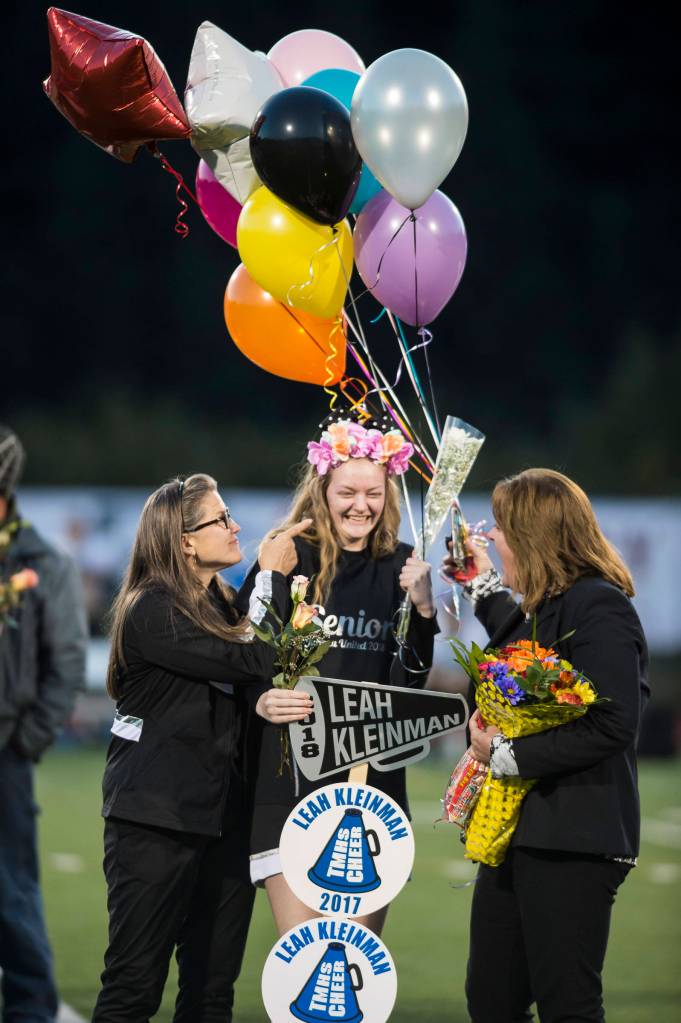 Family and friends celebrate senior night with cheerleaders and players before Juneau Uniteds game against Colony at Thunder Mountain High School on Friday, Sept. 21, 2018. (Michael Penn | Juneau Empire)
