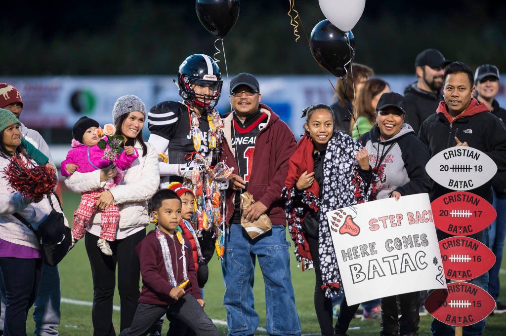 Family and friends celebrate senior night with cheerleaders and players before Juneau Uniteds game against Colony at Thunder Mountain High School on Friday, Sept. 21, 2018. (Michael Penn | Juneau Empire)