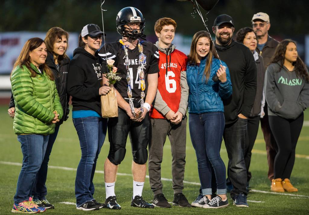 Family and friends celebrate senior night with cheerleaders and players before Juneau Uniteds game against Colony at Thunder Mountain High School on Friday, Sept. 21, 2018. (Michael Penn | Juneau Empire)