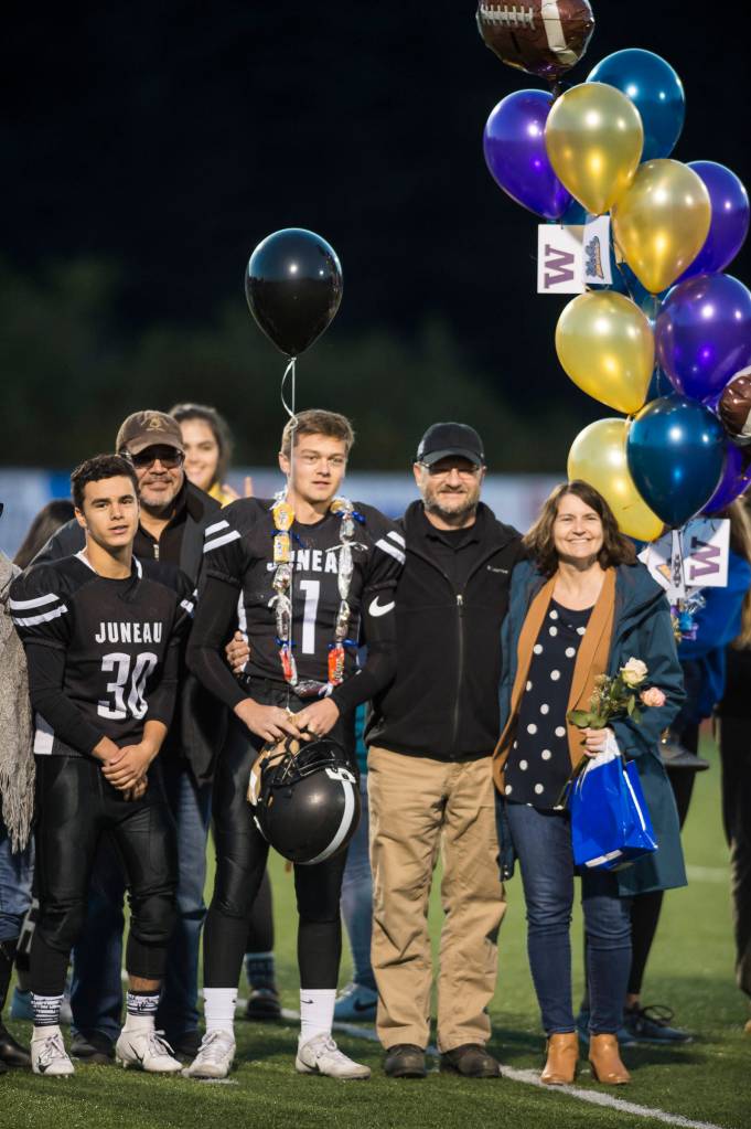 Family and friends celebrate senior night with cheerleaders and players before Juneau Uniteds game against Colony at Thunder Mountain High School on Friday, Sept. 21, 2018. (Michael Penn | Juneau Empire)