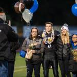 Family and friends celebrate senior night with cheerleaders and players before Juneau Uniteds game against Colony at Thunder Mountain High School on Friday, Sept. 21, 2018. (Michael Penn | Juneau Empire)
