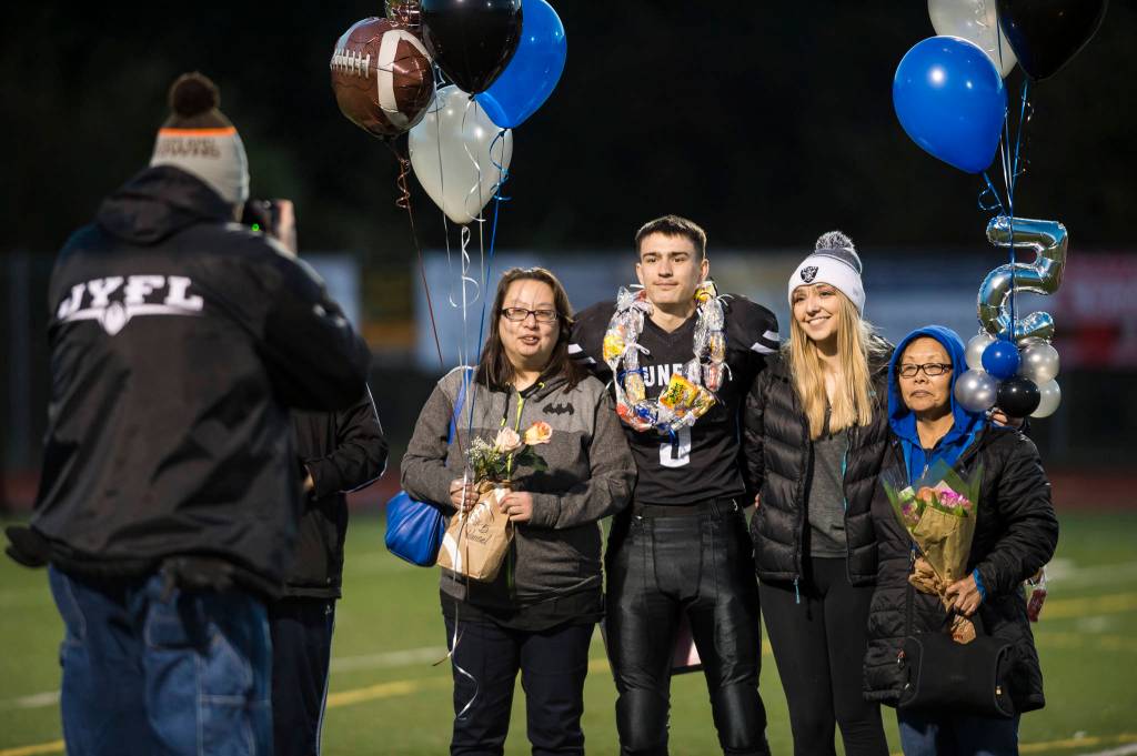 Family and friends celebrate senior night with cheerleaders and players before Juneau Uniteds game against Colony at Thunder Mountain High School on Friday, Sept. 21, 2018. (Michael Penn | Juneau Empire)
