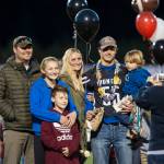Family and friends celebrate senior night with cheerleaders and players before Juneau Uniteds game against Colony at Thunder Mountain High School on Friday, Sept. 21, 2018. (Michael Penn | Juneau Empire)