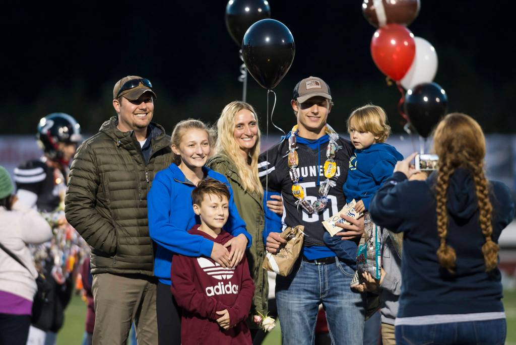 Family and friends celebrate senior night with cheerleaders and players before Juneau Uniteds game against Colony at Thunder Mountain High School on Friday, Sept. 21, 2018. (Michael Penn | Juneau Empire)