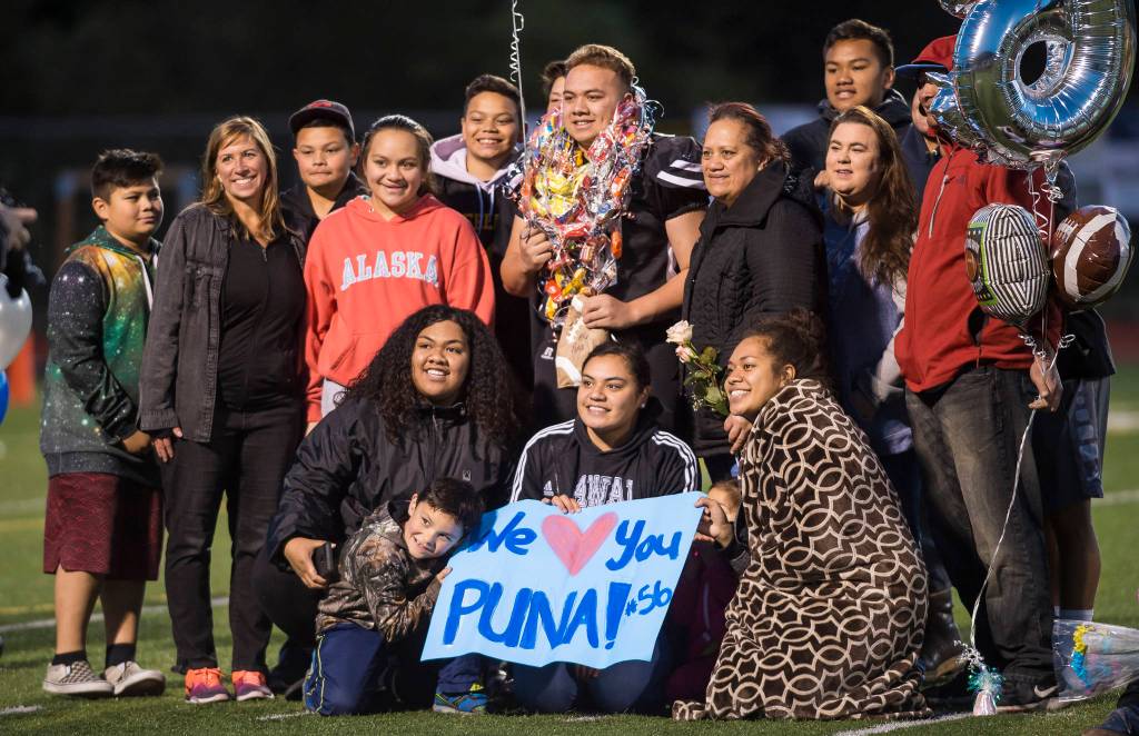 Family and friends celebrate senior Puna Toutaiolepo before Juneau Uniteds game against Colony at Thunder Mountain High School on Friday, Sept. 21, 2018. (Michael Penn | Juneau Empire)